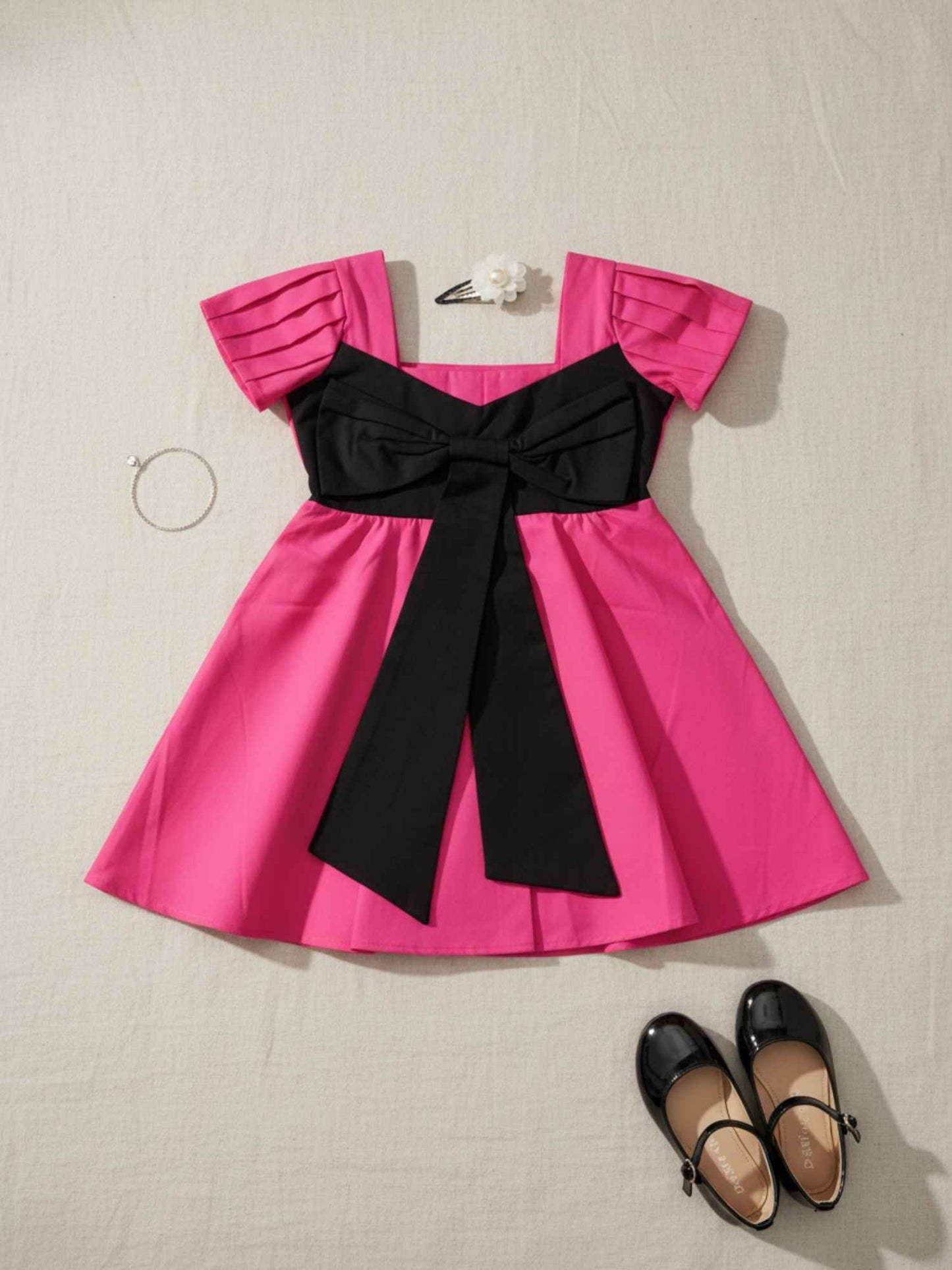 Vibrant Pink Dress with Black Bow Accent