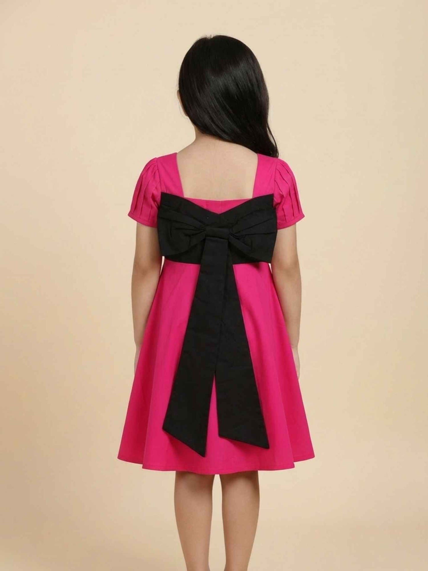 Vibrant Pink Dress with Black Bow Accent
